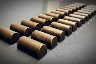 Doppia fila di cioccolatini su piano di metallo